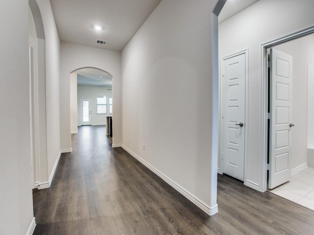 123 Lakeview Circle Pilot Point, TX 76258 - Photo 9 of 39 a view of a hallway with wooden floor