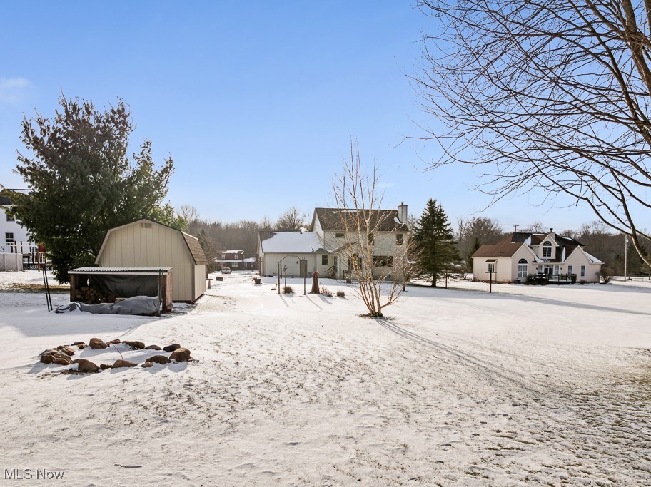 4808 Sherman Road Kent, OH 44240 - Photo 48 of 50 Yard layered in snow featuring an outbuilding and a residential view