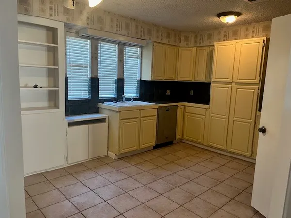 a kitchen with a sink and cabinets
