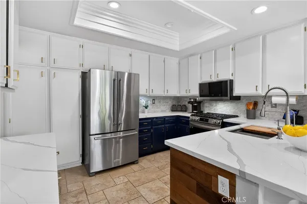 a kitchen with stainless steel appliances a refrigerator stove and microwave