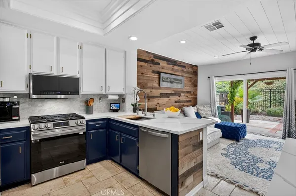 a kitchen with a stove sink and microwave