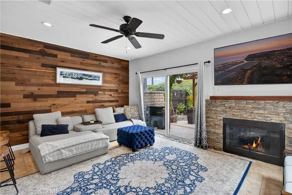 a living room with furniture a rug and a fireplace