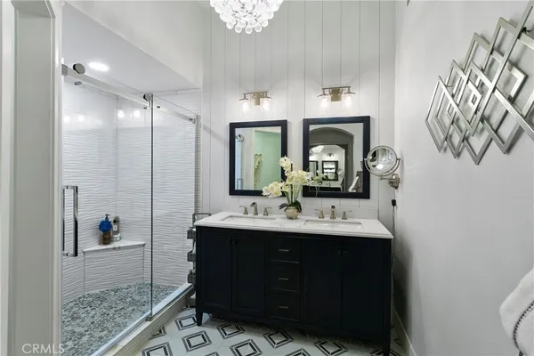 a bathroom with a sink and a mirror with toilet