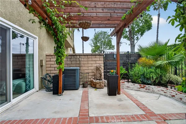 a view of a patio with a table and chairs and potted plants