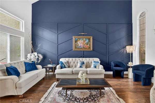 a living room with furniture and a chandelier