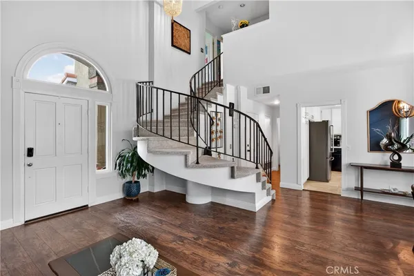 a view of entryway livingroom and hall with wooden floor