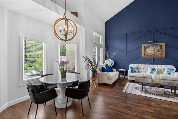 a living room with furniture a table and a large window