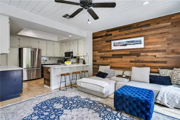 a living room with furniture and kitchen view