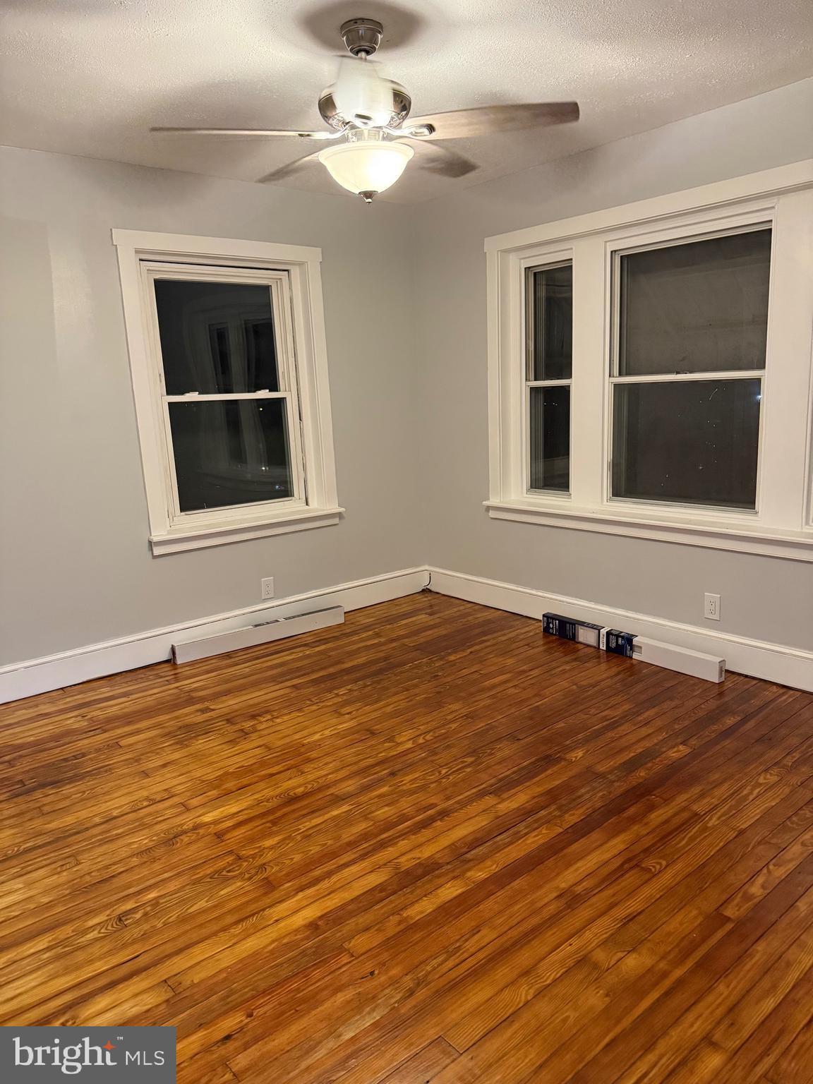 399 Sunset Road Reading, PA 19611 - Photo 12 of 18 a view of an empty room with wooden floor and a window