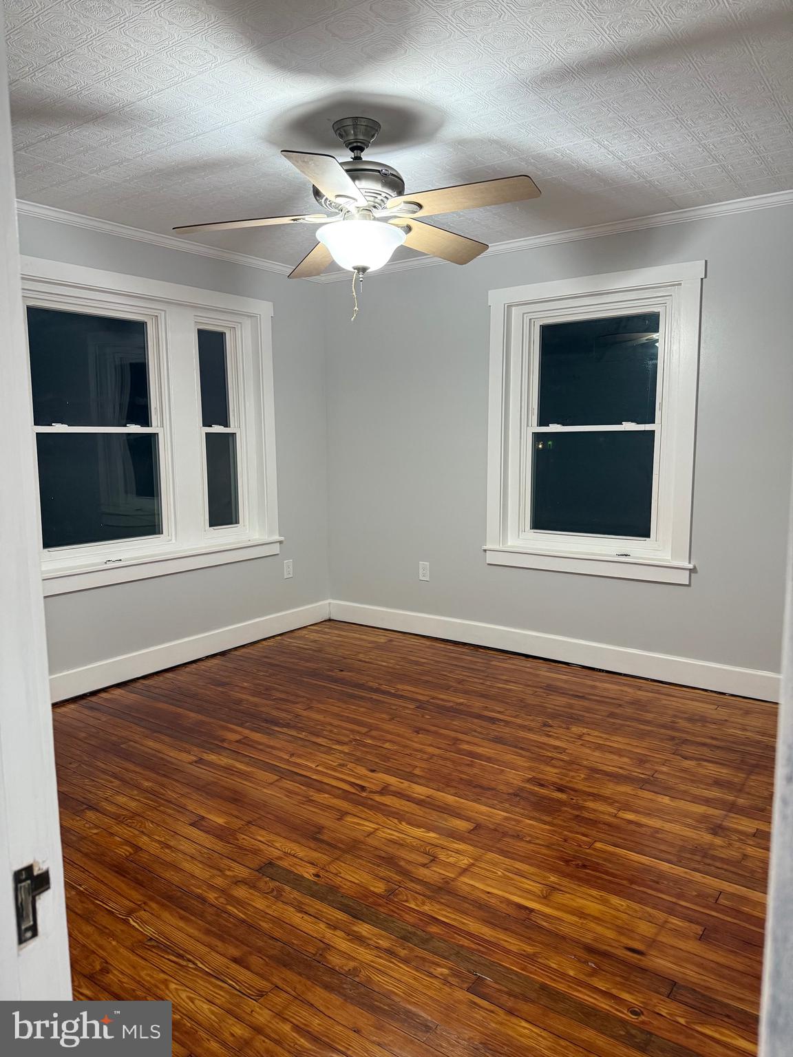 399 Sunset Road Reading, PA 19611 - Photo 14 of 18 a view of an empty room with wooden floor and cabinet