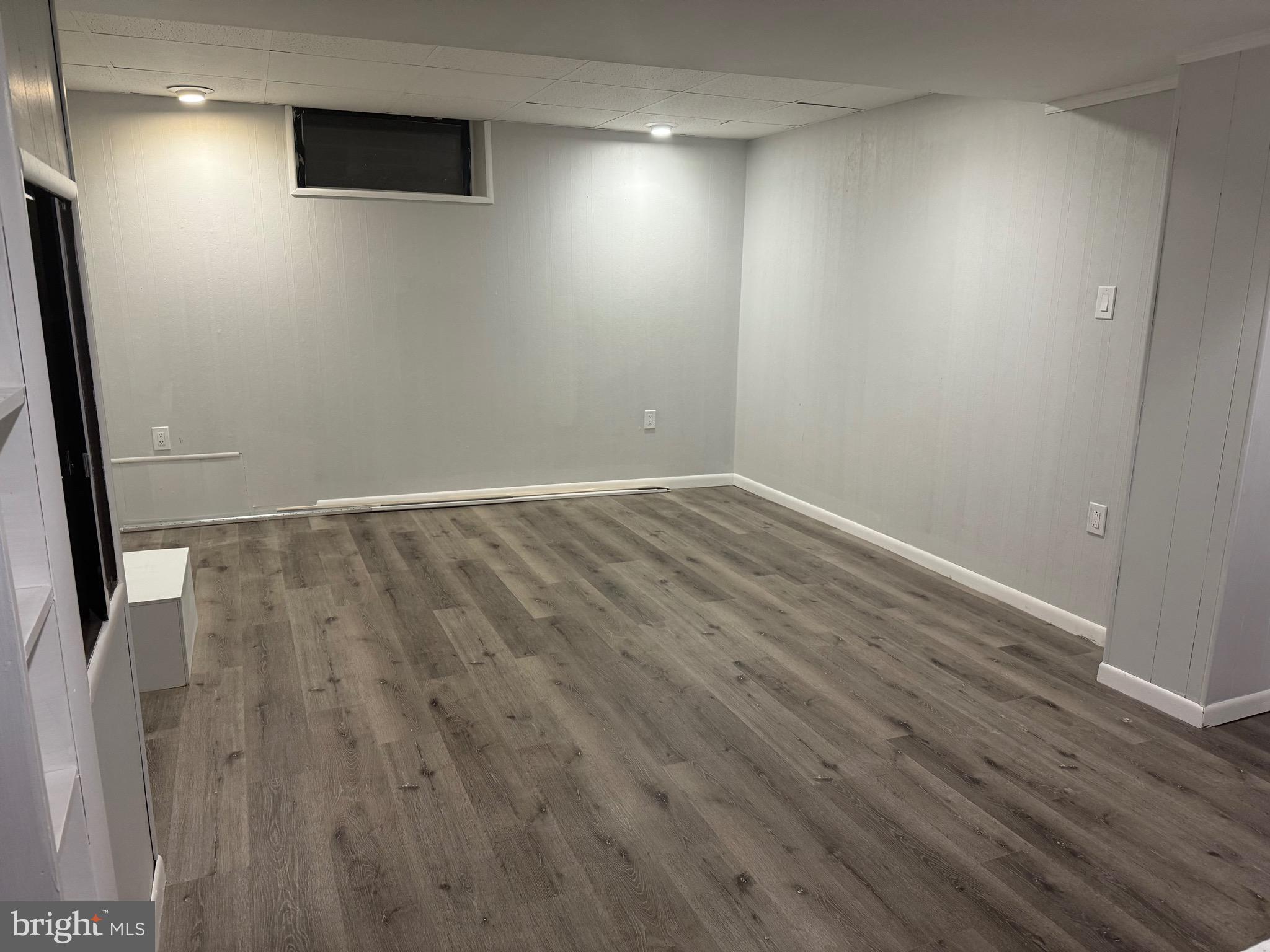 399 Sunset Road Reading, PA 19611 - Photo 15 of 18 an empty room with wooden floor and windows