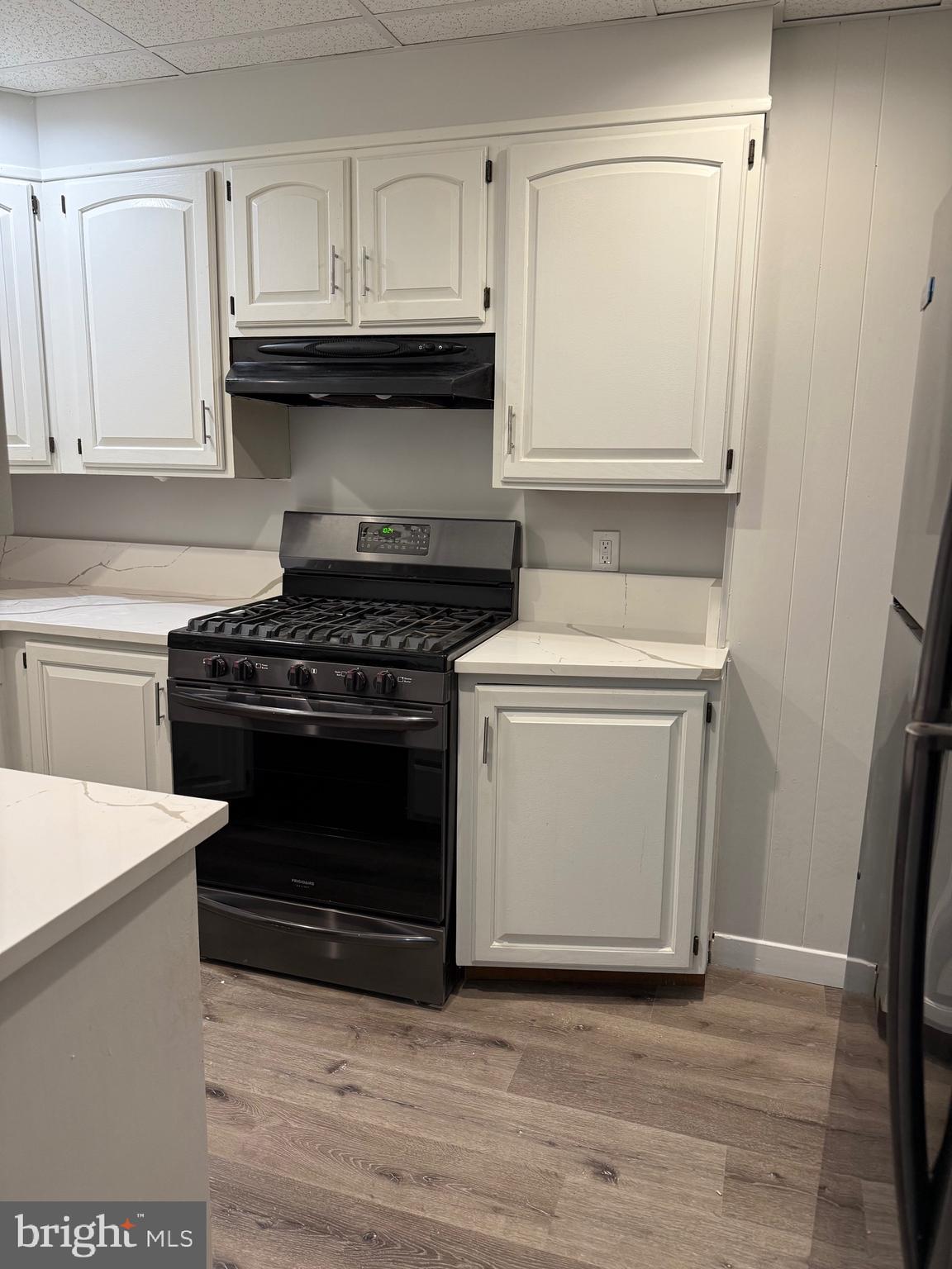 399 Sunset Road Reading, PA 19611 - Photo 4 of 18 a kitchen with granite countertop white cabinets and white appliances