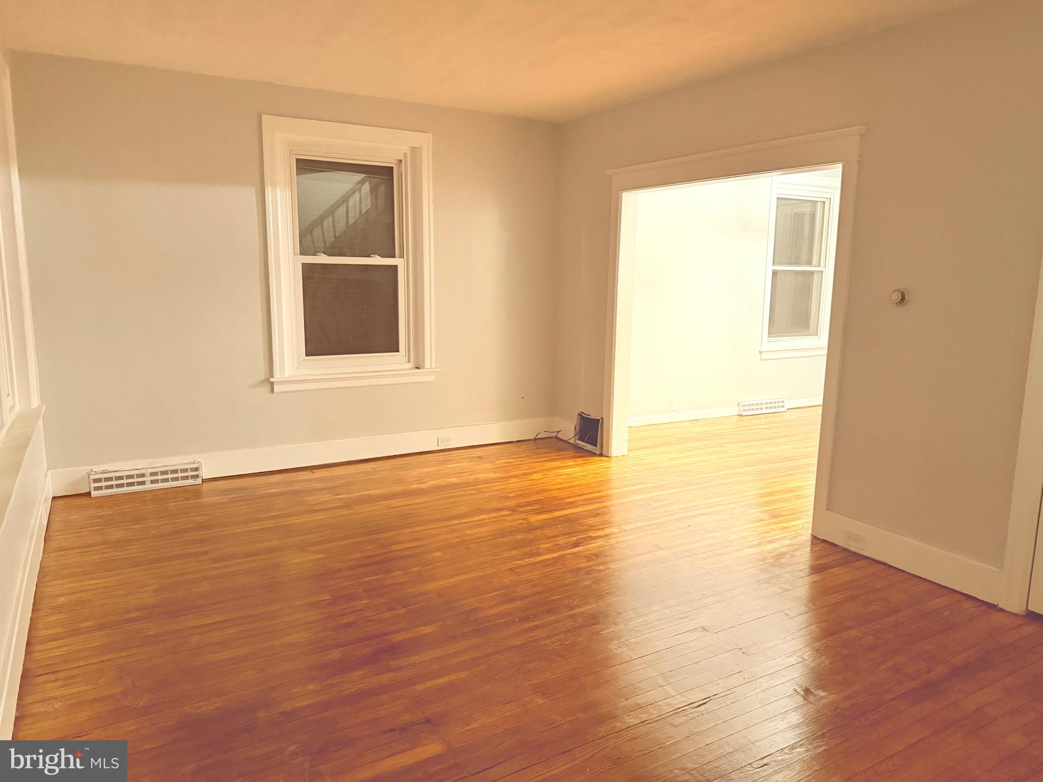 399 Sunset Road Reading, PA 19611 - Photo 5 of 18 a view of an empty room with wooden floor and a window