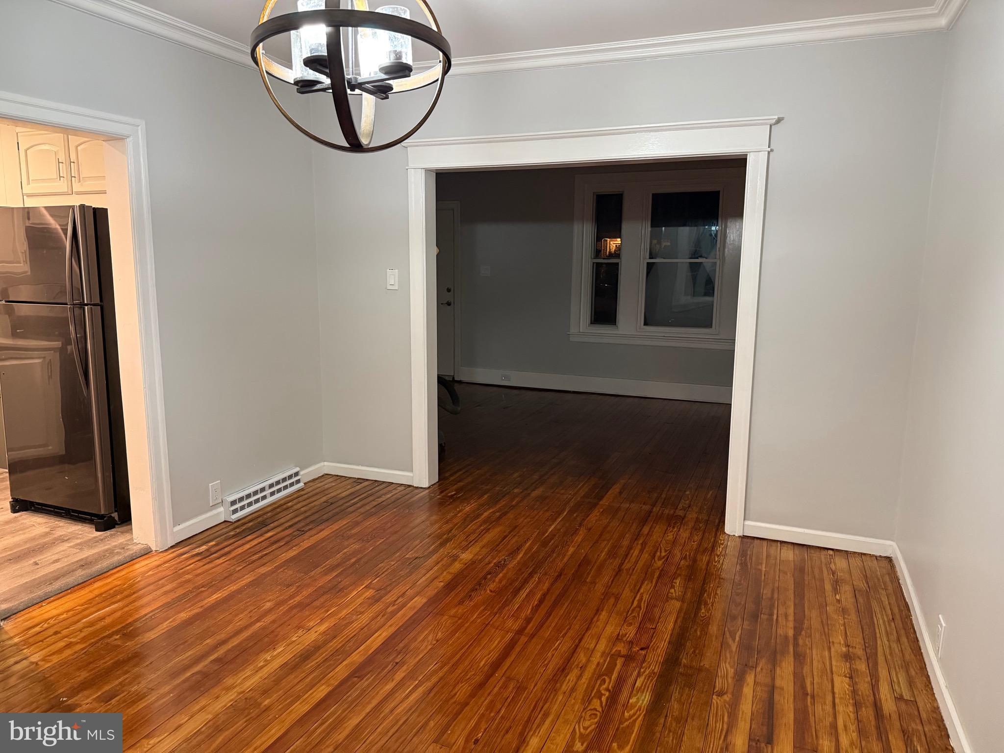399 Sunset Road Reading, PA 19611 - Photo 7 of 18 a view of an empty room with wooden floor and a window