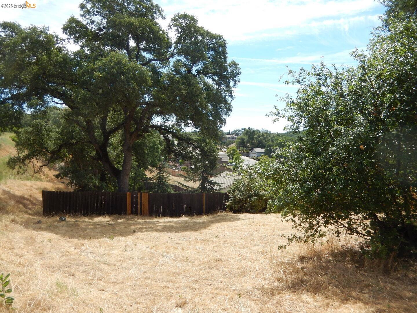512 Crazy Horse Road Cameron Park, CA 95682 - Photo 16 of 18 a view of a yard covered with snow in the yard