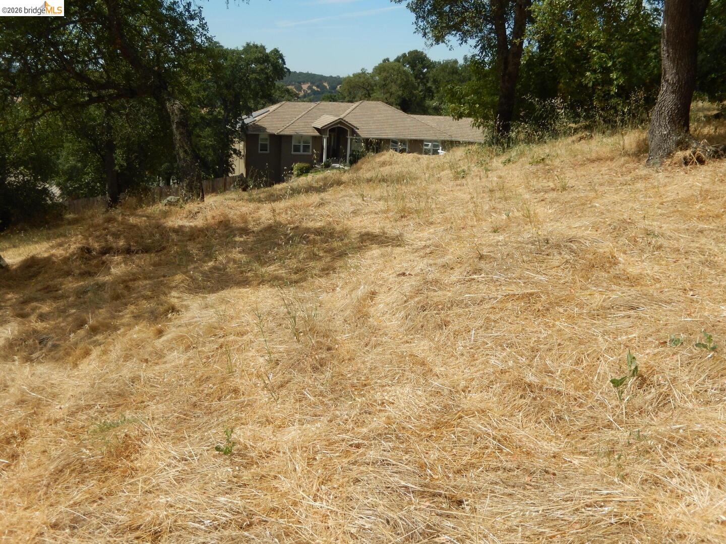 512 Crazy Horse Road Cameron Park, CA 95682 - Photo 17 of 18 a view of a house with a yard