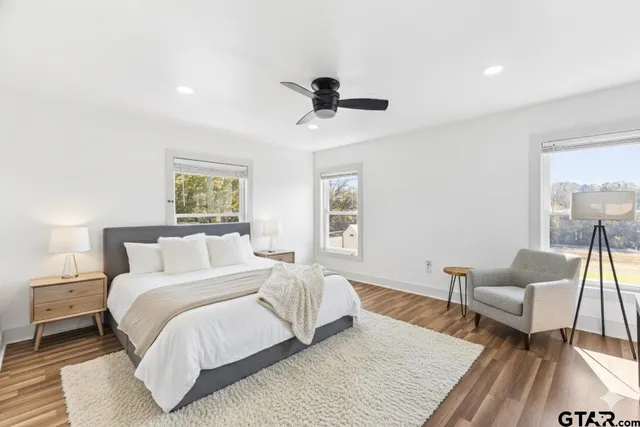 a bathroom with a granite countertop sink mirror toilet and bathtub