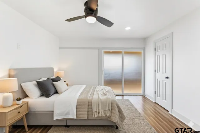 a bedroom with a large bed and a chandelier