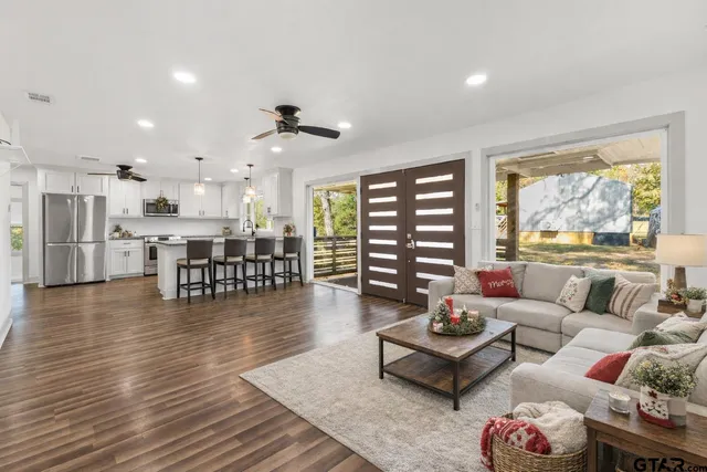 a kitchen with stainless steel appliances granite countertop a refrigerator a sink and a granite counter tops