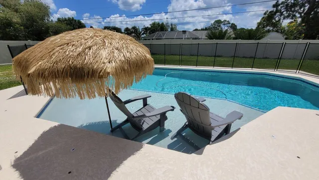 a view of a backyard with sitting area