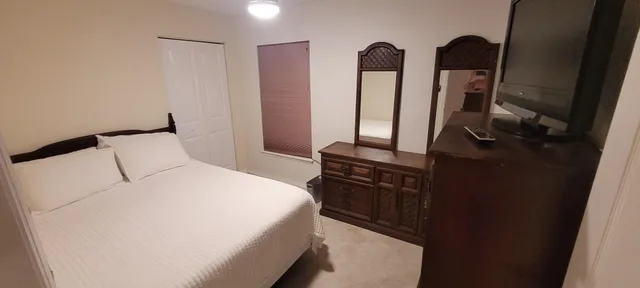 a bedroom with bed and sliding door