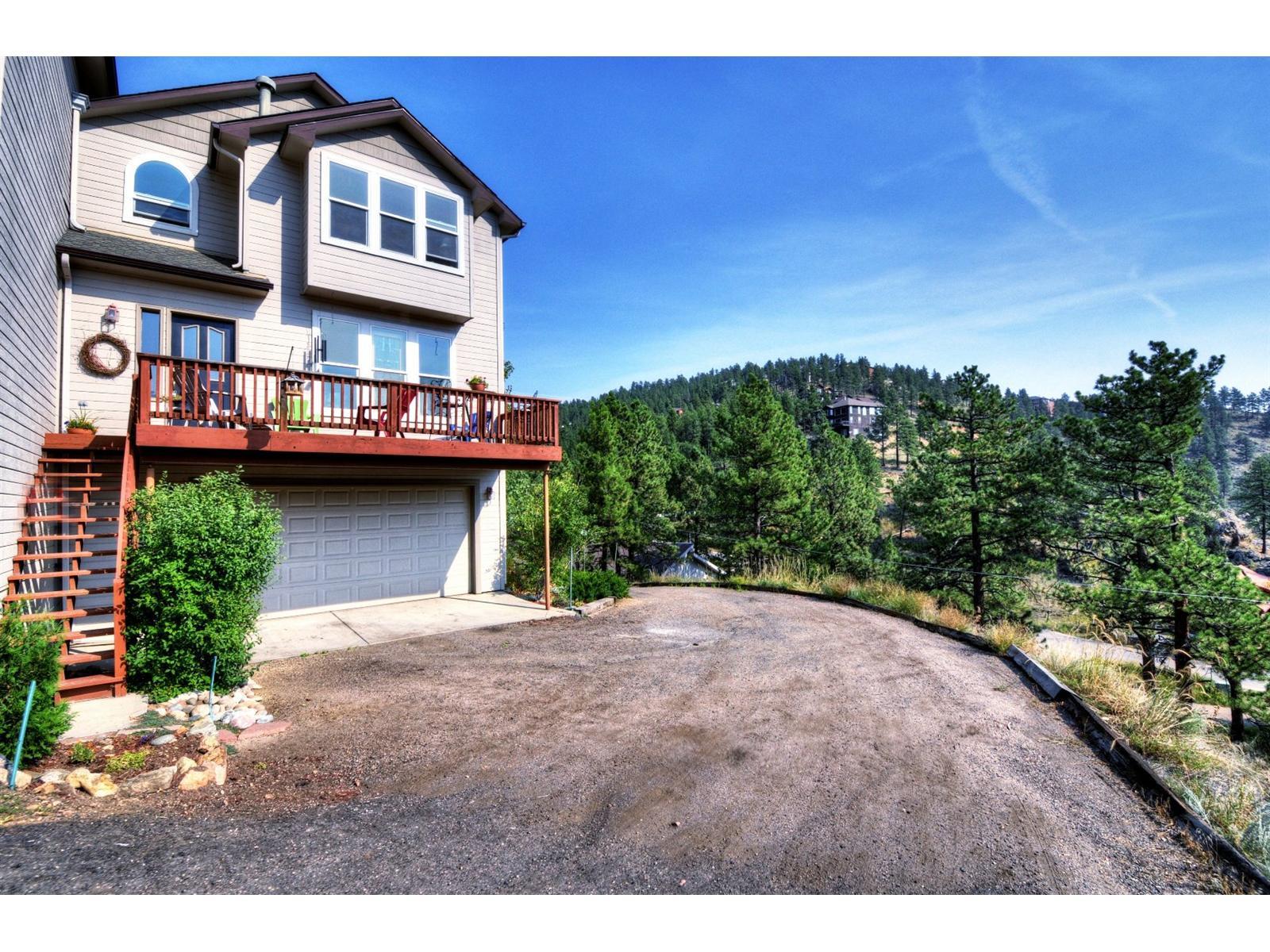 3345 Russell Gulch Road Evergreen, CO 80439 - Photo 1 of 1 a view of a house with a backyard and plants