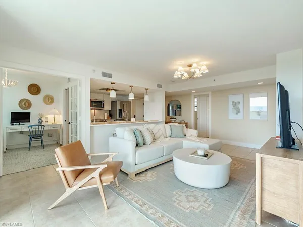 a living room with furniture and a chandelier