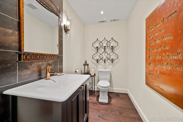 a bathroom with a sink a toilet and a mirror