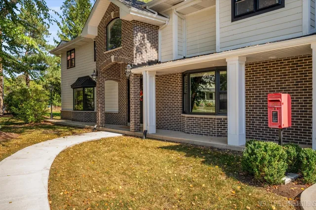 a view of a house with brick walls