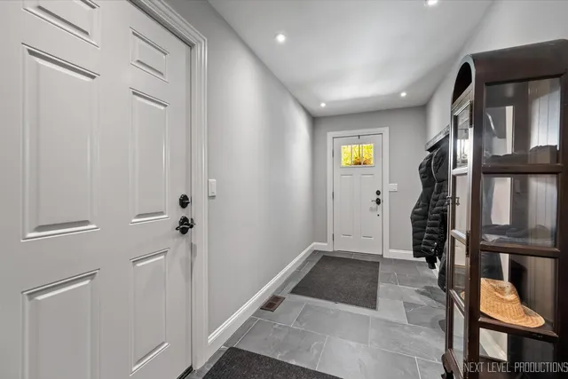 a view of an entryway with wooden floor