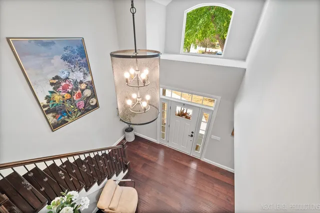 a front view of a house with wooden floor and windows