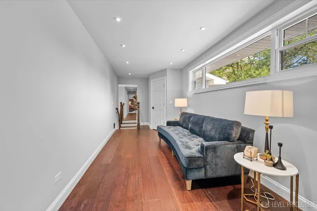 a living room with furniture and a wooden floor