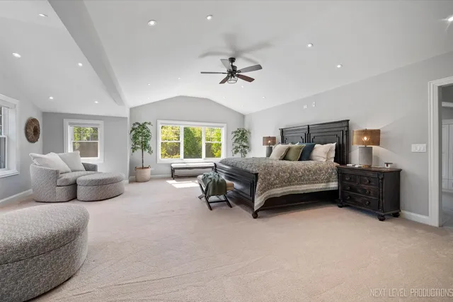 a bedroom with furniture and a large window