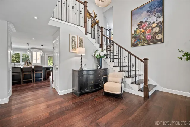 a view of a hallway with dining room and wooden floor