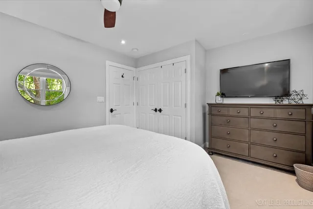 a bedroom with a bed and a television