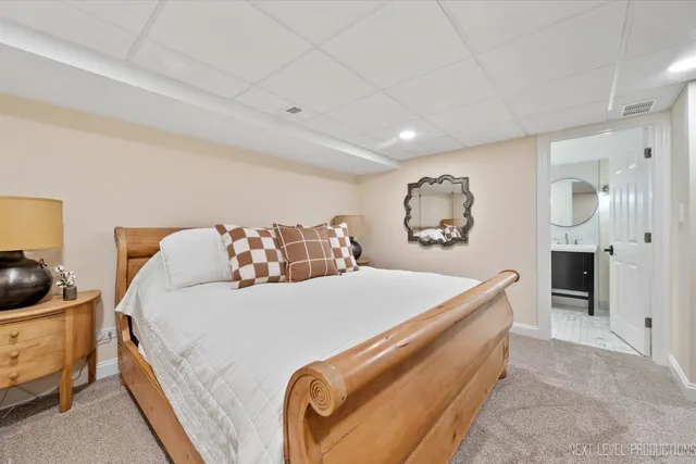 a bed sitting in a bedroom next to a dresser with kitchen