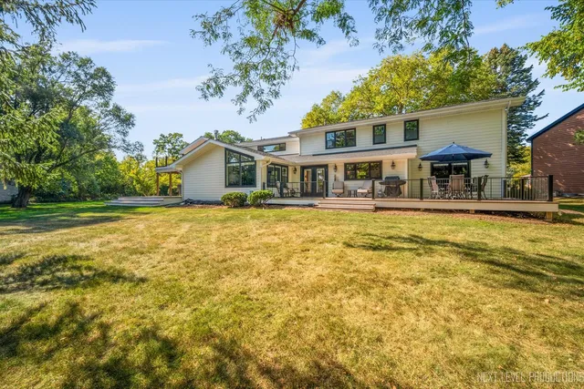 a front view of house with yard and trees around