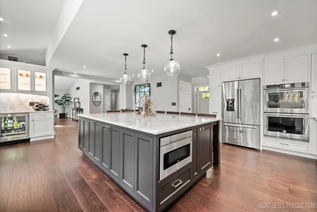 a kitchen with stainless steel appliances granite countertop a stove and a refrigerator