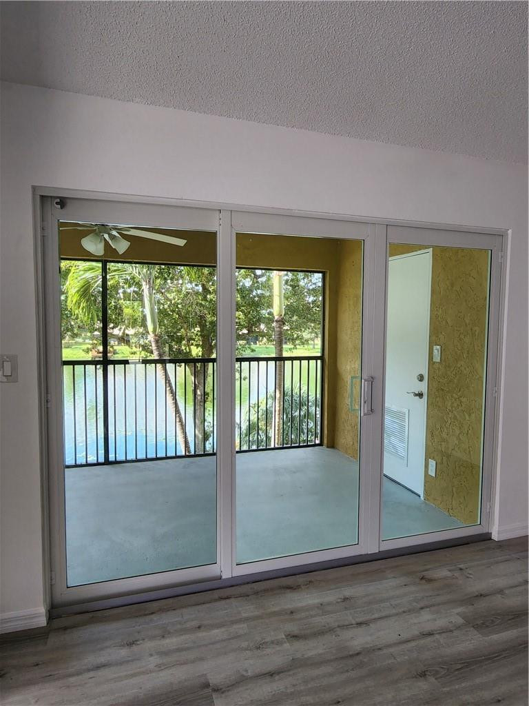 Undisclosed Address Pompano Beach, FL 33063 - Photo 12 of 30 a view of an empty room with wooden floor and a window