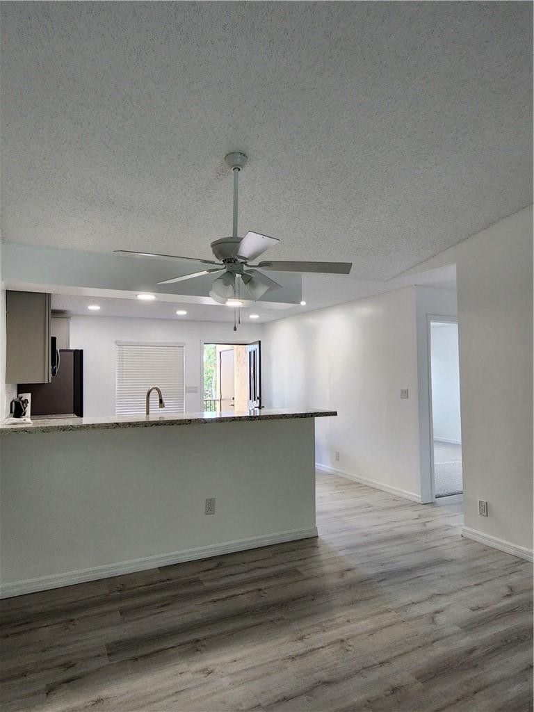 Undisclosed Address Pompano Beach, FL 33063 - Photo 17 of 30 a view of a kitchen with a sink and wooden floor