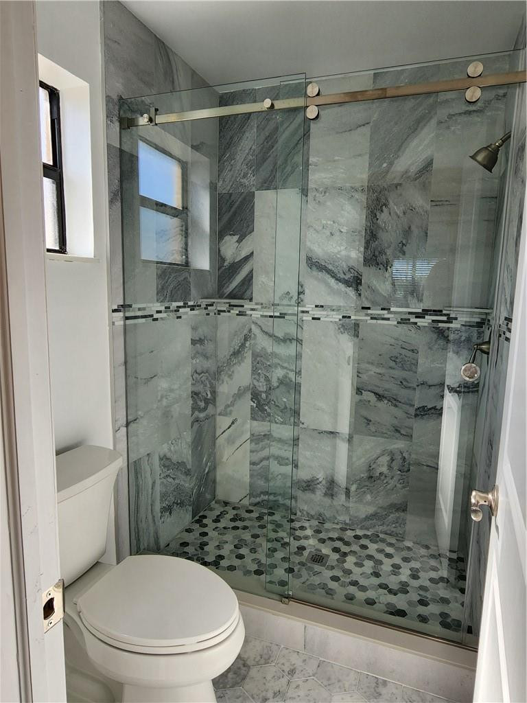 Undisclosed Address Pompano Beach, FL 33063 - Photo 21 of 30 a bathroom with a shower and toilet