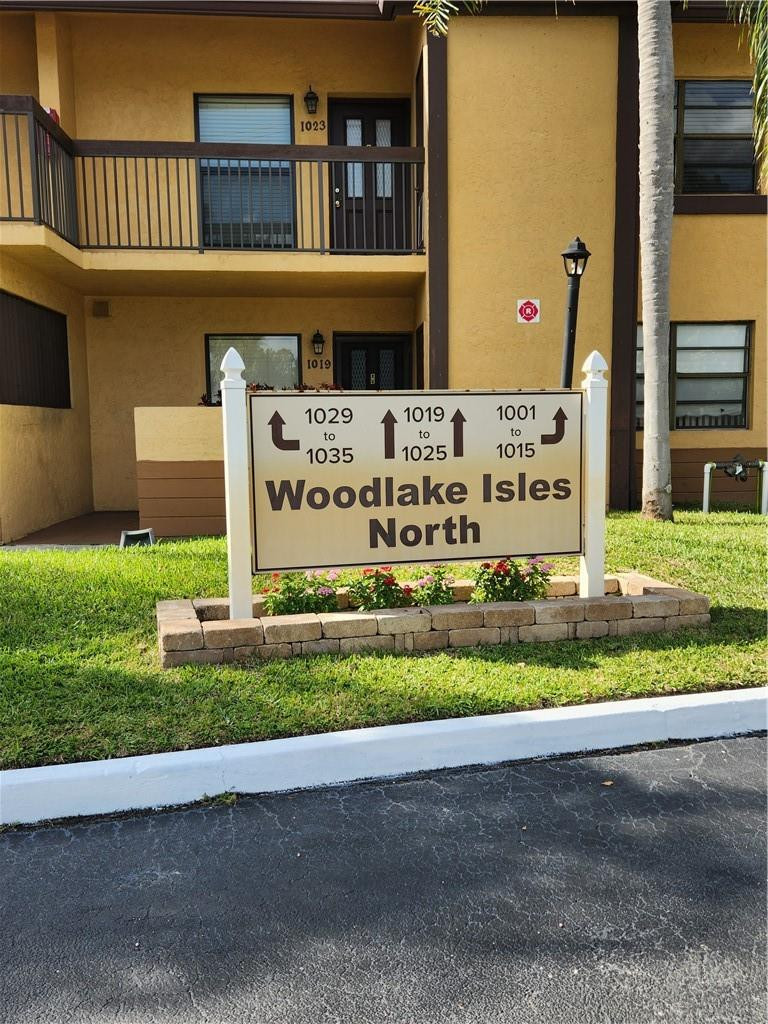 Undisclosed Address Pompano Beach, FL 33063 - Photo 30 of 30 a front view of a house with a yard and garage