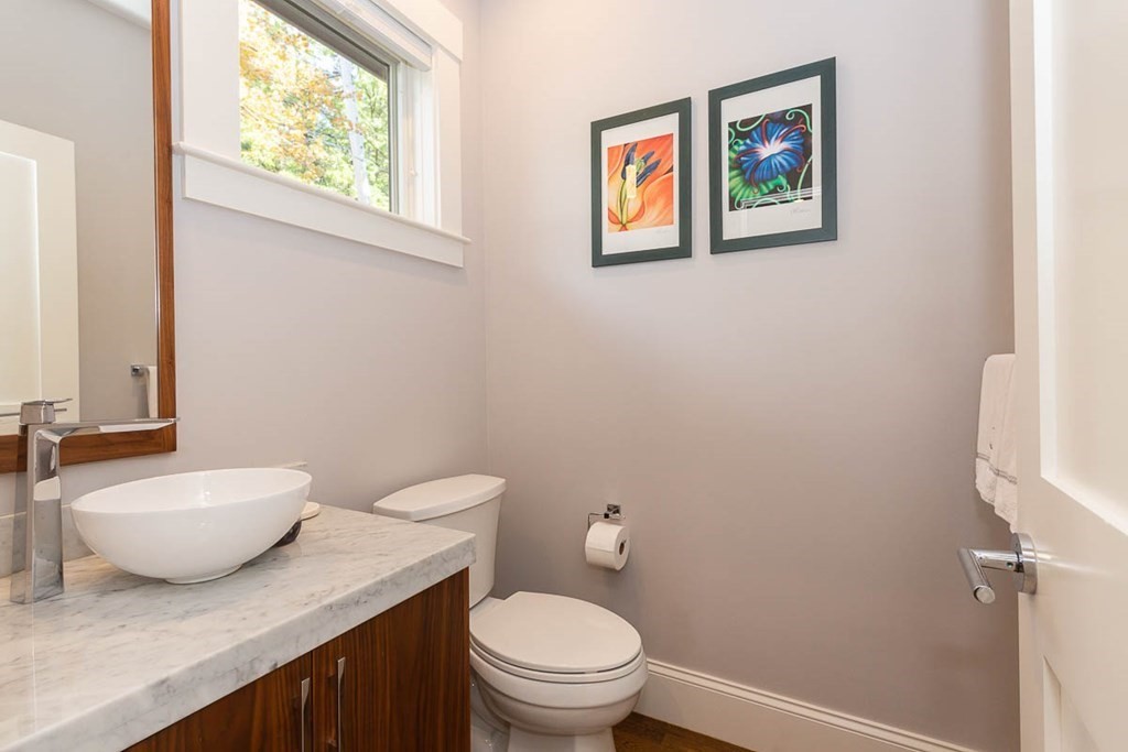 26 Beaconsfield Road, Unit 26 Brookline, MA 02445 - Photo 16 of 35 a bathroom with a granite countertop toilet and a sink