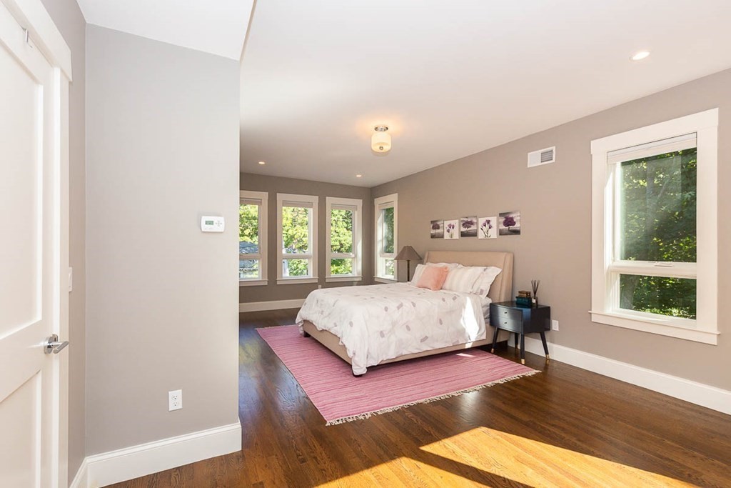 26 Beaconsfield Road, Unit 26 Brookline, MA 02445 - Photo 25 of 35 a spacious bedroom with a large bed and a large window