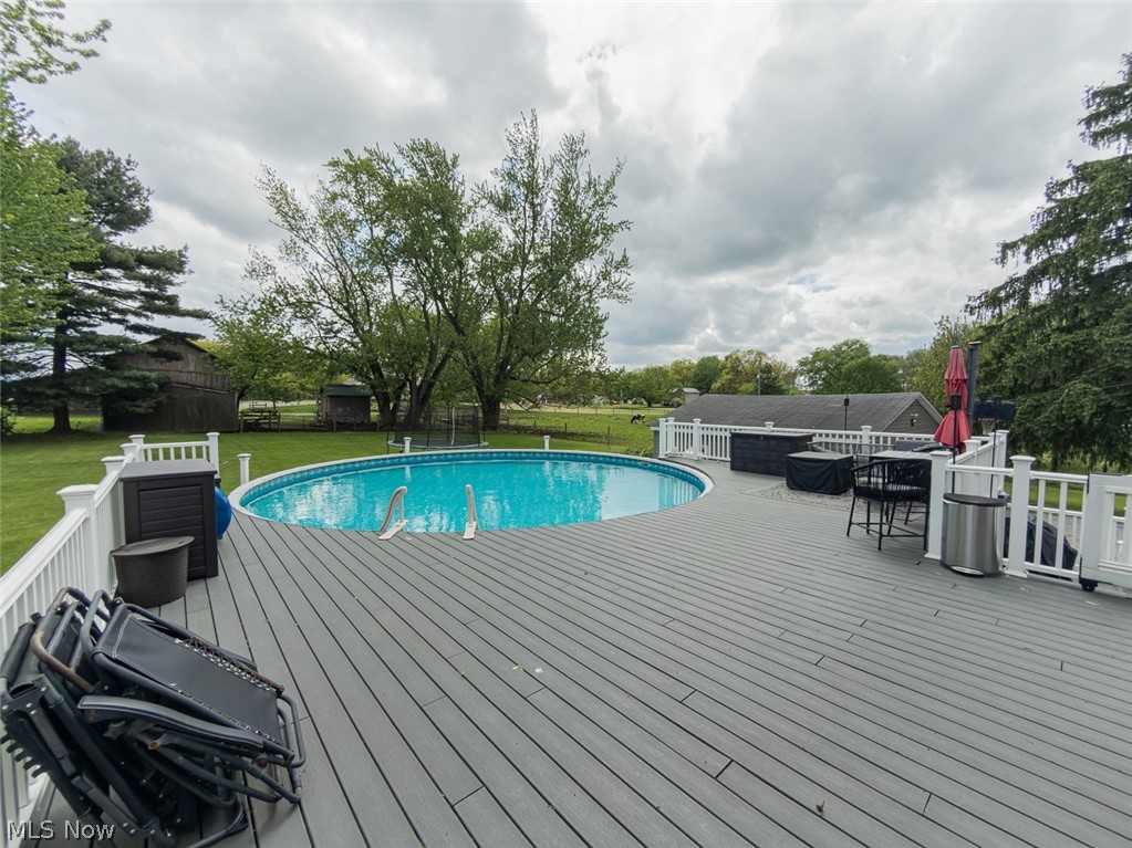 13429 West Calla Road Salem, OH 44460 - Photo 20 of 27 Expansive outdoor deck featuring an above-ground pool with a surrounding white railing