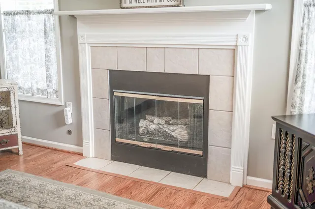 a living room with a fireplace and a painting on the wall