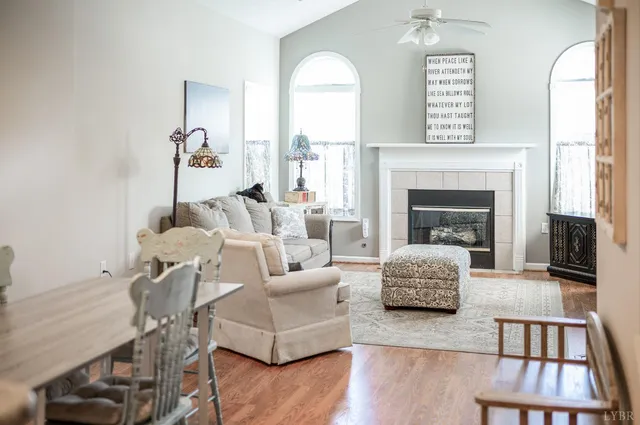 a living room with furniture fireplace and window