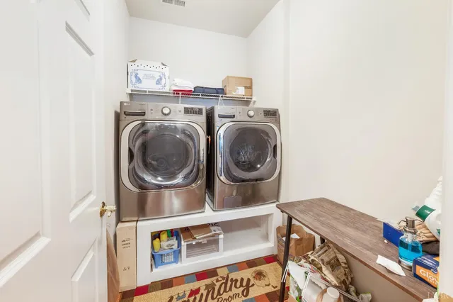 a spacious bedroom with a bed a couch and a dresser next to a window