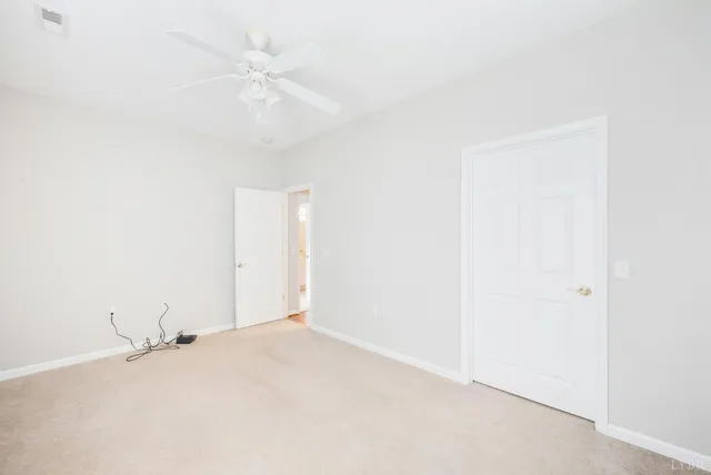 a view of front door with hallway and wooden floor
