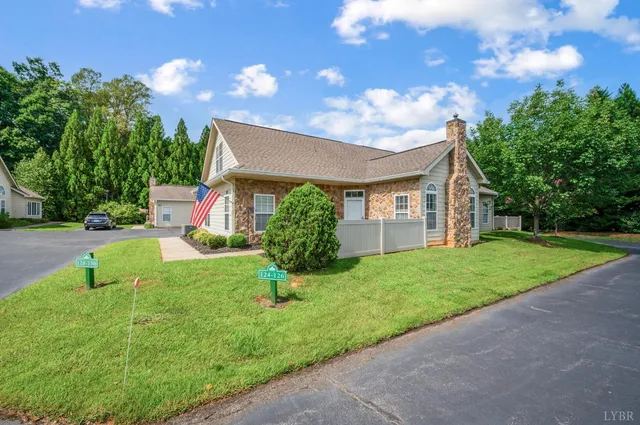 a view of a house with backyard and a tree